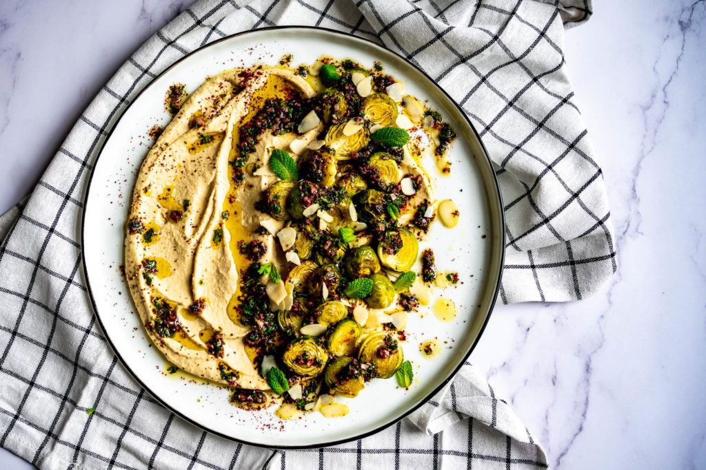 Hummus with roasted Brussels sprouts and sumac-mint dressing